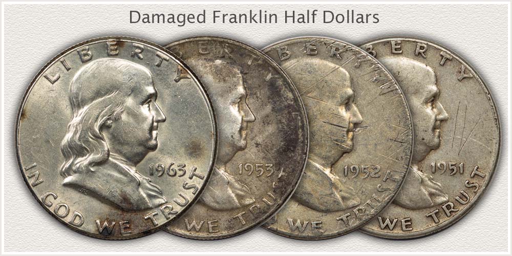 Four Franklin Half Dollars with Damage to Surfaces
